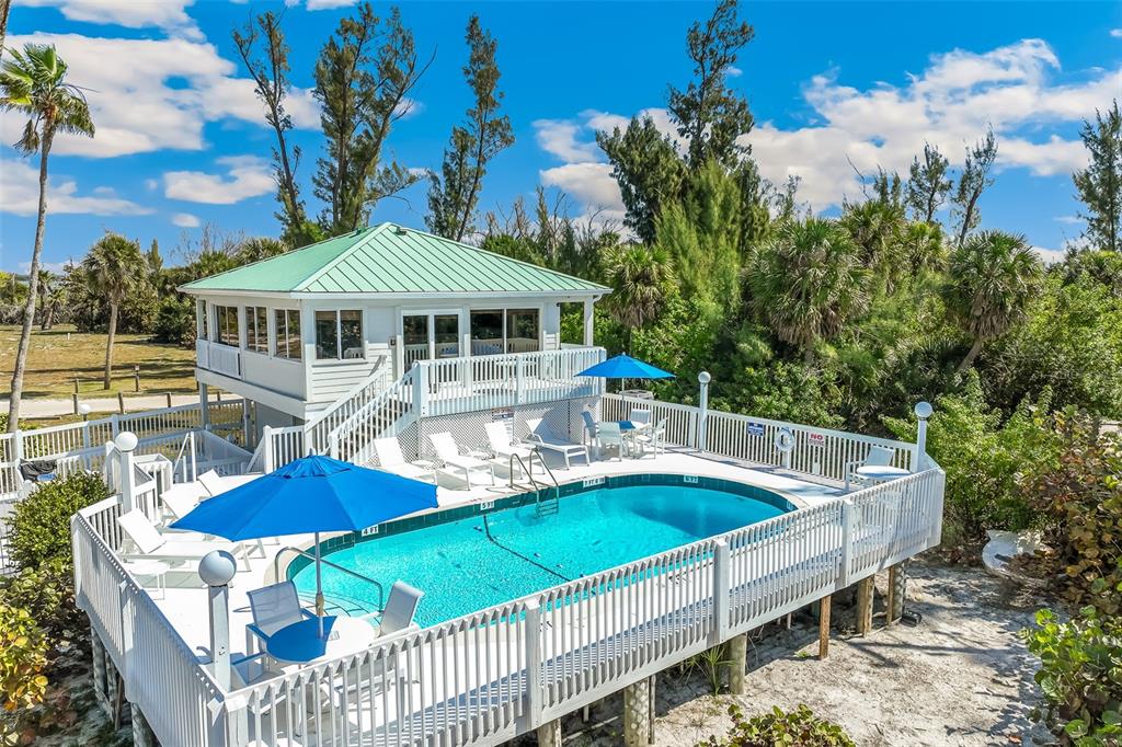 11000 Placida Road, Unit 1504 Placida, FL 33946 - Photo 65 of 73 a view of a patio with chairs and a table