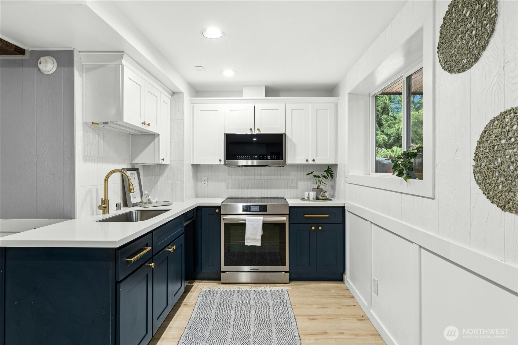 18152 145th Avenue Southeast Renton, WA 98058 - Photo 23 of 40 a kitchen with a stove a sink and a microwave