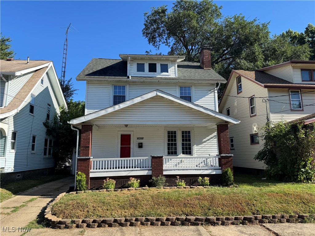 2425 7th Street Northwest Canton, OH 44708 - Photo 1 of 19 American foursquare style home with a porch, a front lawn, and a chimney