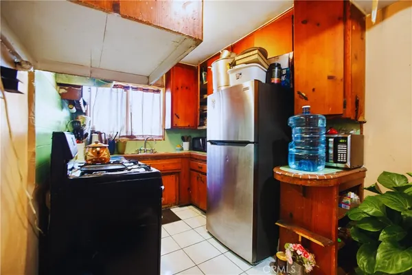 a kitchen with stainless steel appliances granite countertop a refrigerator and a stove