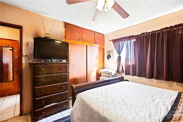 a bedroom with a bed and a flat screen tv