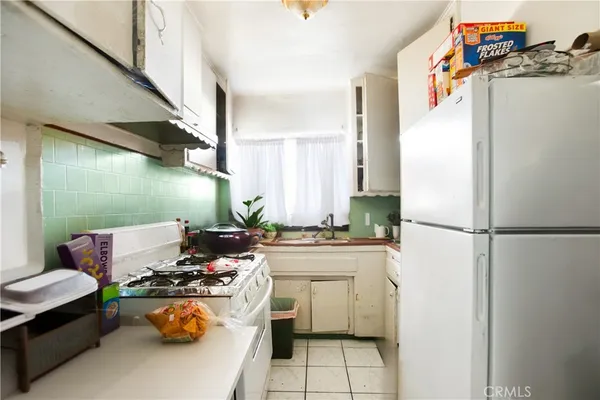 a kitchen with a refrigerator and a stove