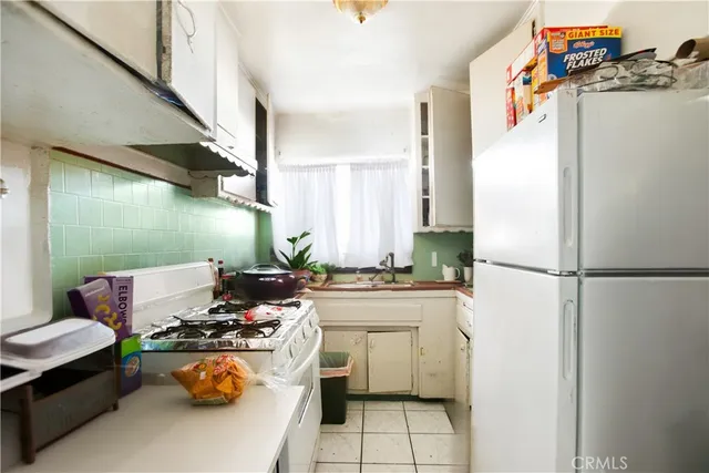 a kitchen with a refrigerator and a stove
