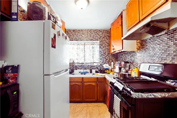 a kitchen with a stove and a refrigerator