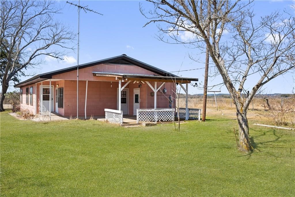 5692 Ranch Road 1623 Blanco, TX 78606 - Photo 1 of 1 a view of a house with a yard and a large tree