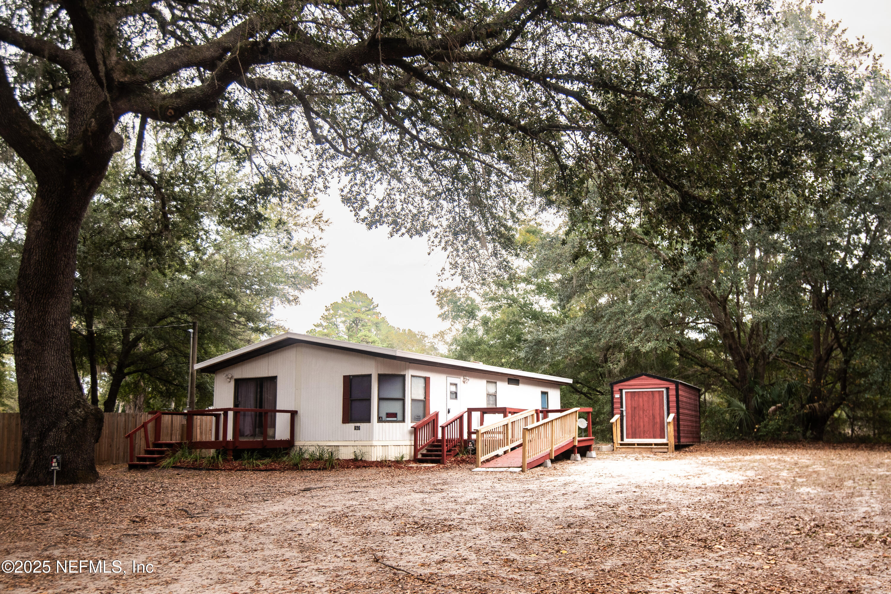 a view of a house with a yard covered in snow