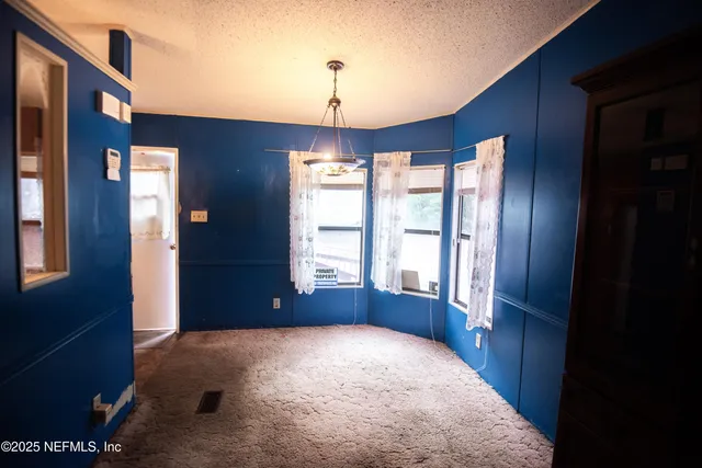 a tree in front of a white house