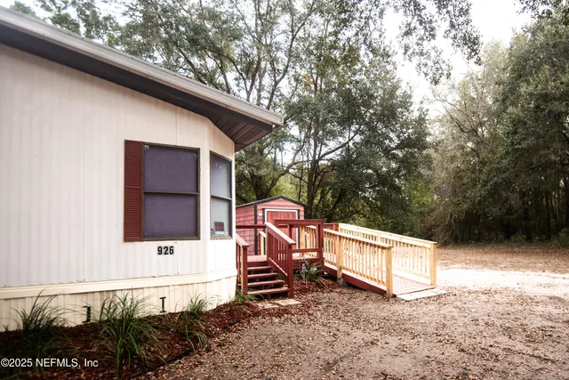 a backyard of a house with table and chairs