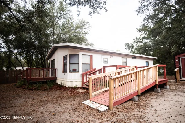 a view of a house with a yard and deck