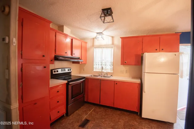 a kitchen with stainless steel appliances granite countertop a refrigerator a sink dishwasher a microwave oven with cabinets and wooden floor