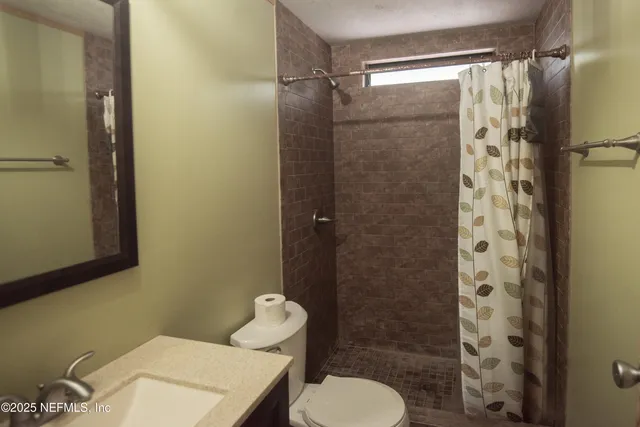 a bathroom with a shower and a toilet