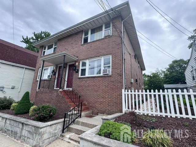 760 Mary Street, Unit B Perth Amboy, NJ 08861 - Photo 10 of 10 a view of a brick house with a small yard and plants