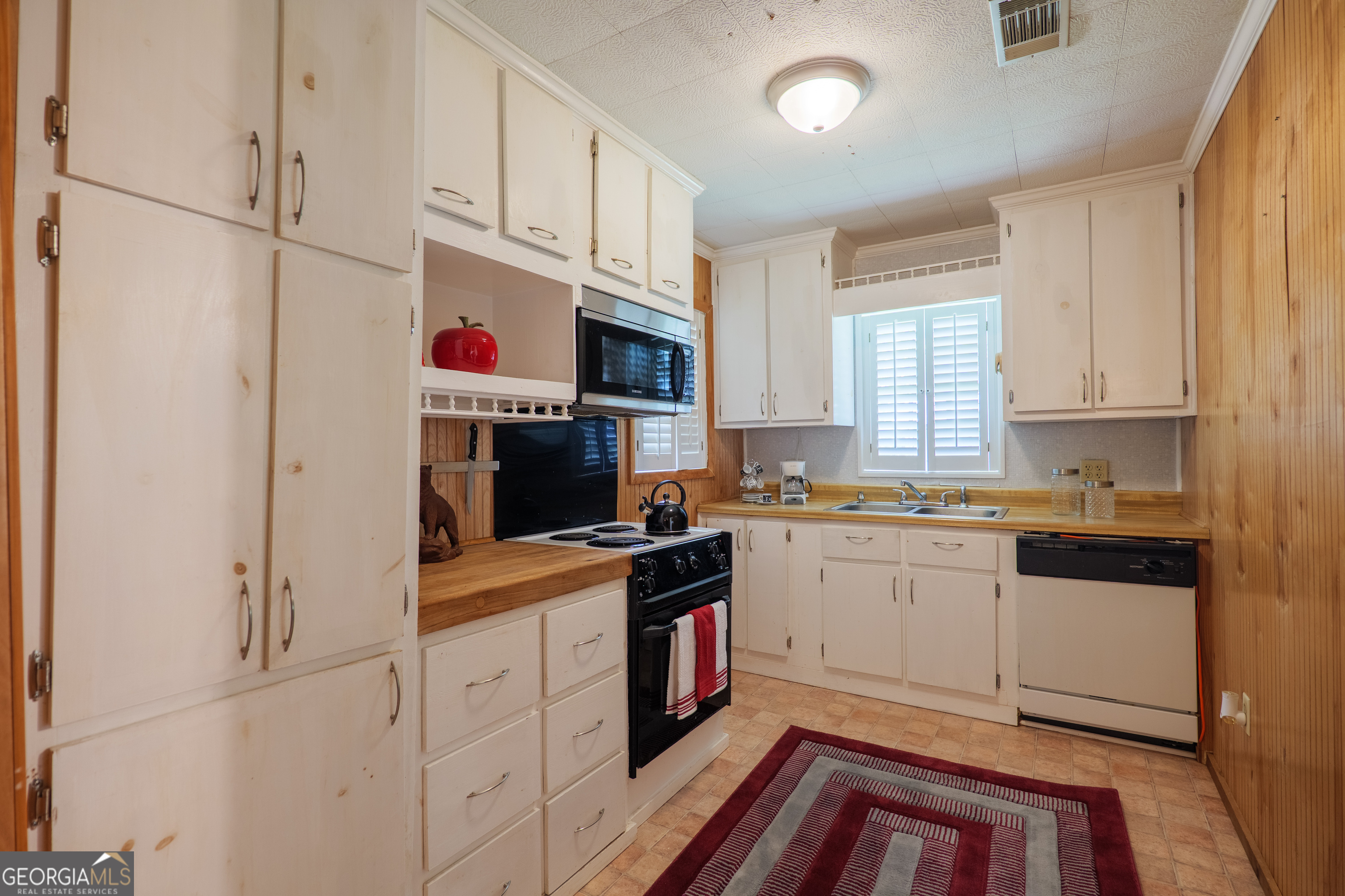 106 Nancy Avenue Fargo, GA 31631 - Photo 16 of 41 a kitchen with cabinets appliances a sink and a window