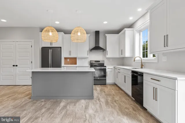 a kitchen with a sink and a stove top oven