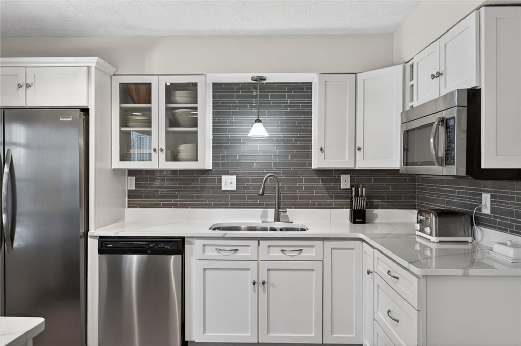 9 Scotland Place Northwest Atlanta, GA 30318 - Photo 16 of 49 a kitchen with stainless steel appliances granite countertop a sink stove and refrigerator