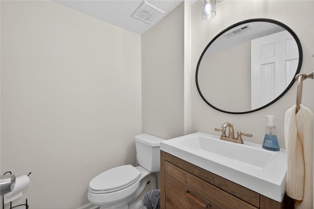 9 Scotland Place Northwest Atlanta, GA 30318 - Photo 19 of 49 a bathroom with a sink a mirror and a toilet