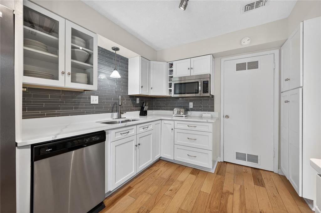 9 Scotland Place Northwest Atlanta, GA 30318 - Photo 2 of 49 a kitchen with stainless steel appliances granite countertop a sink cabinets and wooden floor