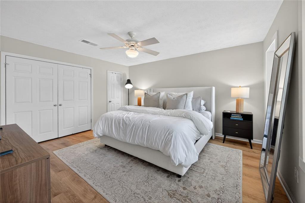9 Scotland Place Northwest Atlanta, GA 30318 - Photo 22 of 49 a spacious bedroom with a bed and a cabinets