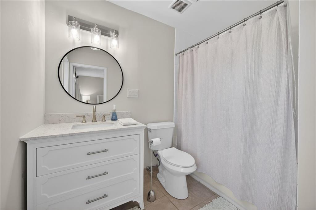 9 Scotland Place Northwest Atlanta, GA 30318 - Photo 23 of 49 a bathroom with a toilet a sink and a mirror