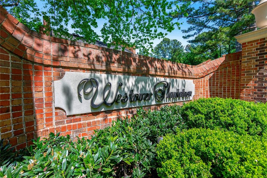 9 Scotland Place Northwest Atlanta, GA 30318 - Photo 32 of 49 a view of sign board with plants in front of gate