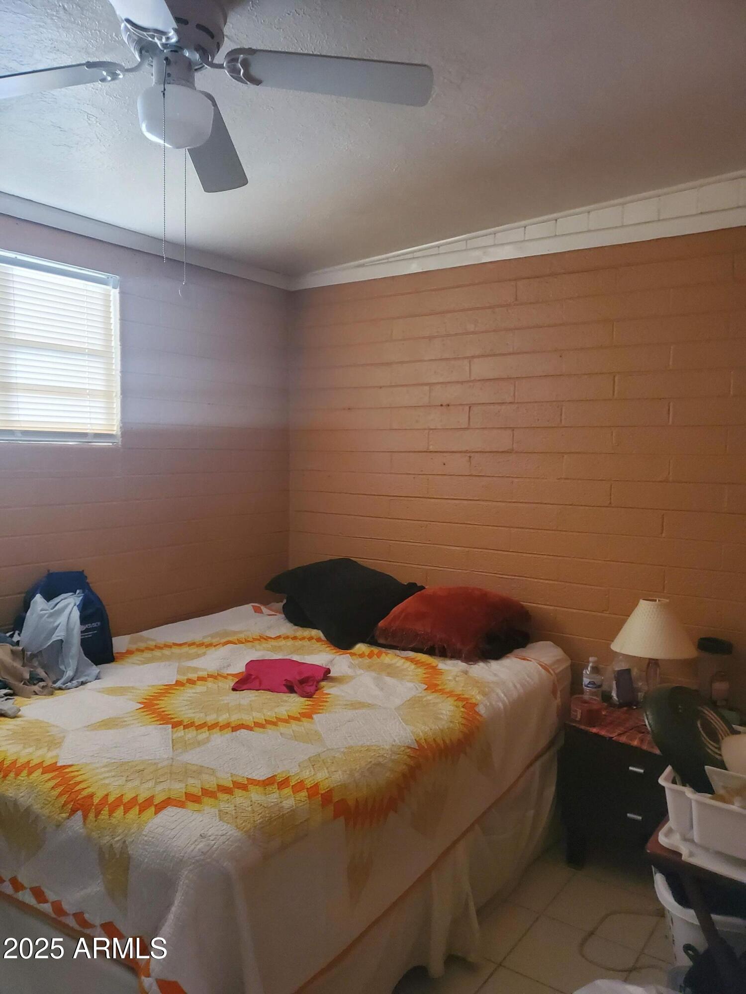 3041 East Osborn Road Phoenix, AZ 85016 - Photo 12 of 22 a bedroom with a bed and a chandelier fan