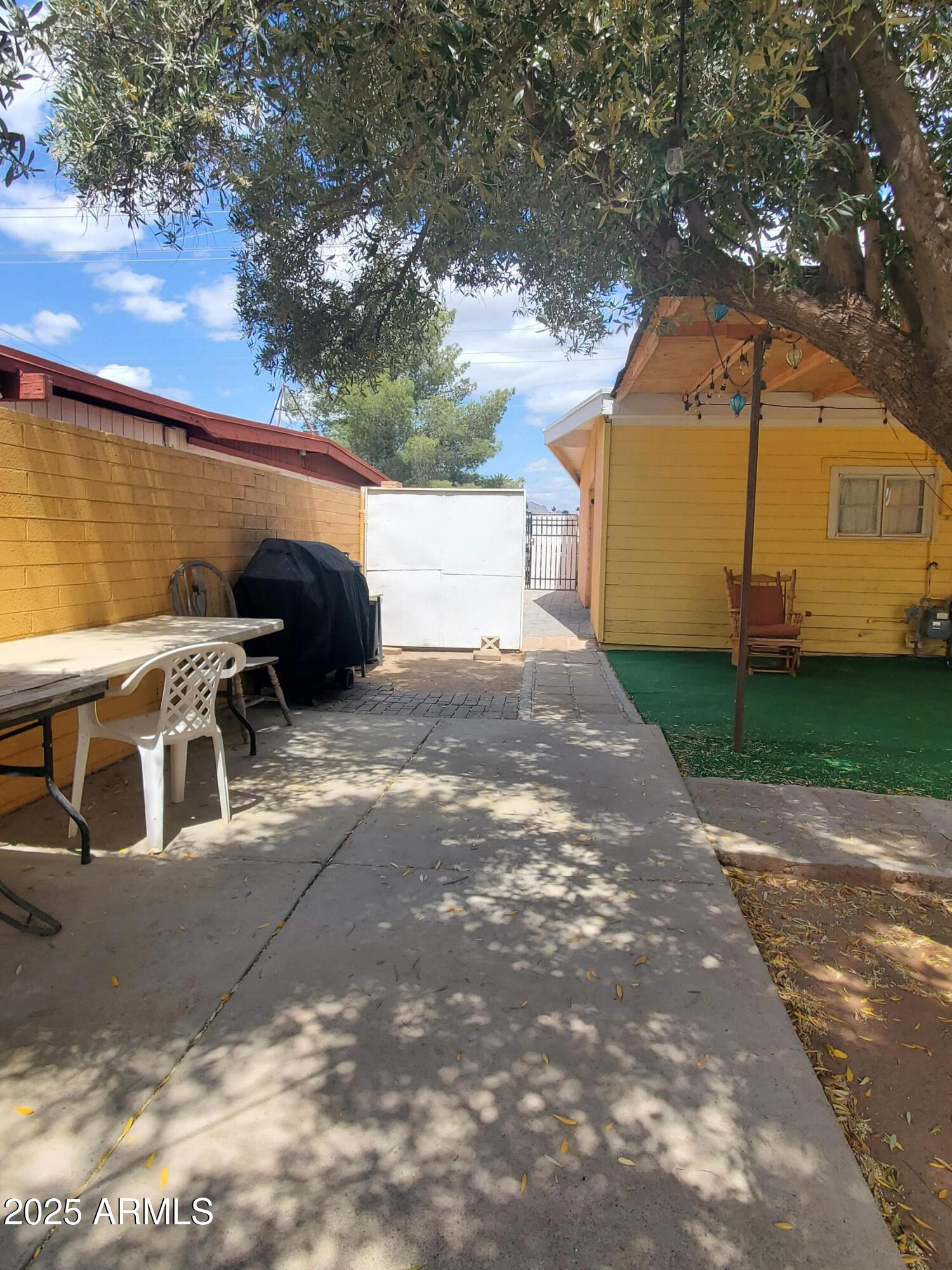 3041 East Osborn Road Phoenix, AZ 85016 - Photo 14 of 22 a view of a patio with table and chairs under an umbrella