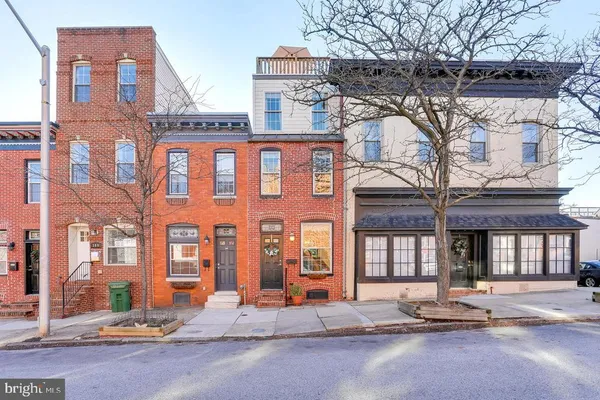 a front view of a building with a garden
