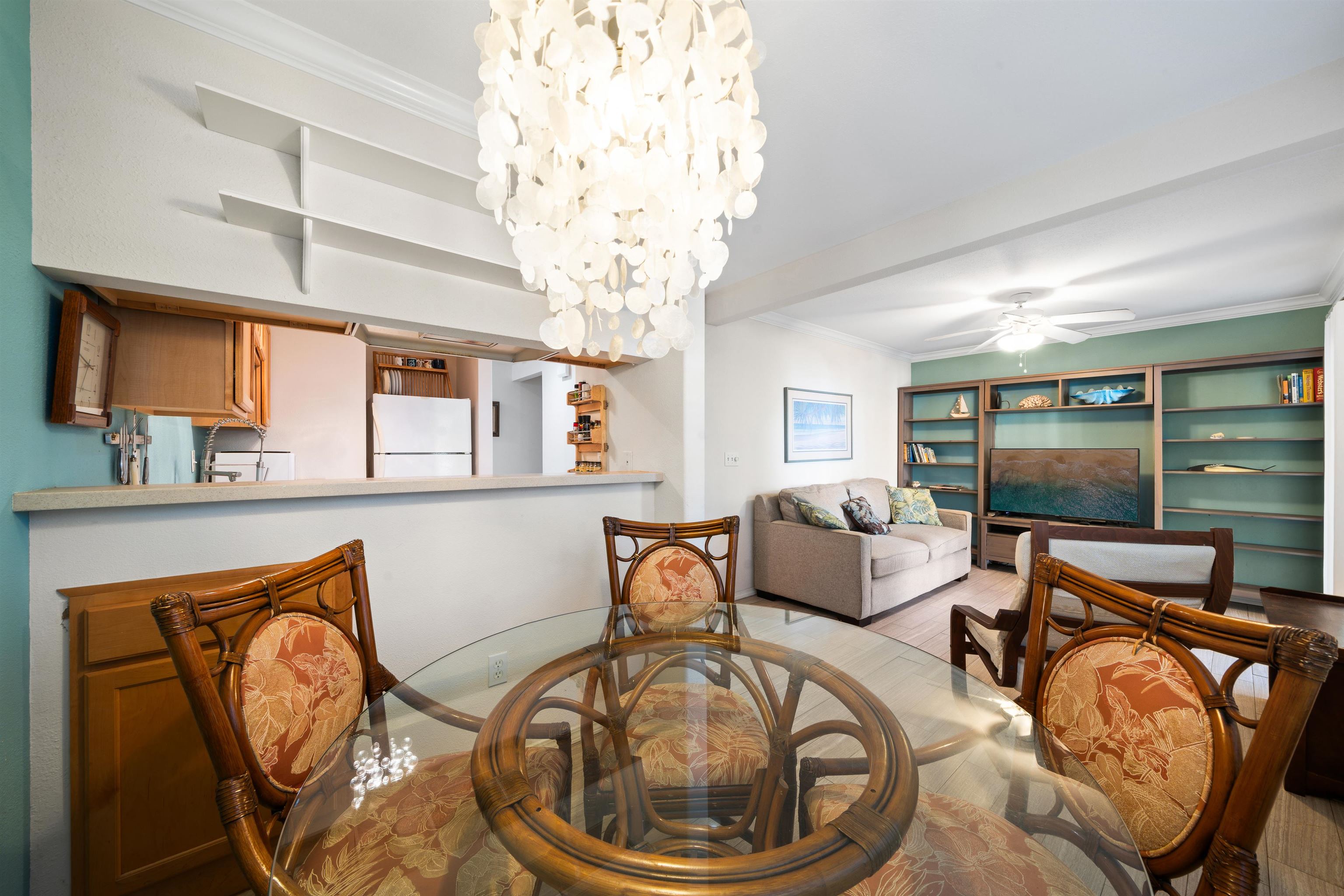 65 Halili Lane, Unit 10F Kihei, HI 96753 - Photo 12 of 48 a living room with furniture and a chandelier