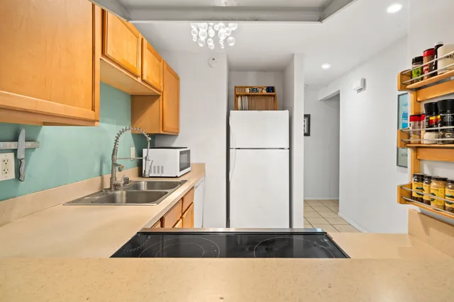 a kitchen with refrigerator and cabinets