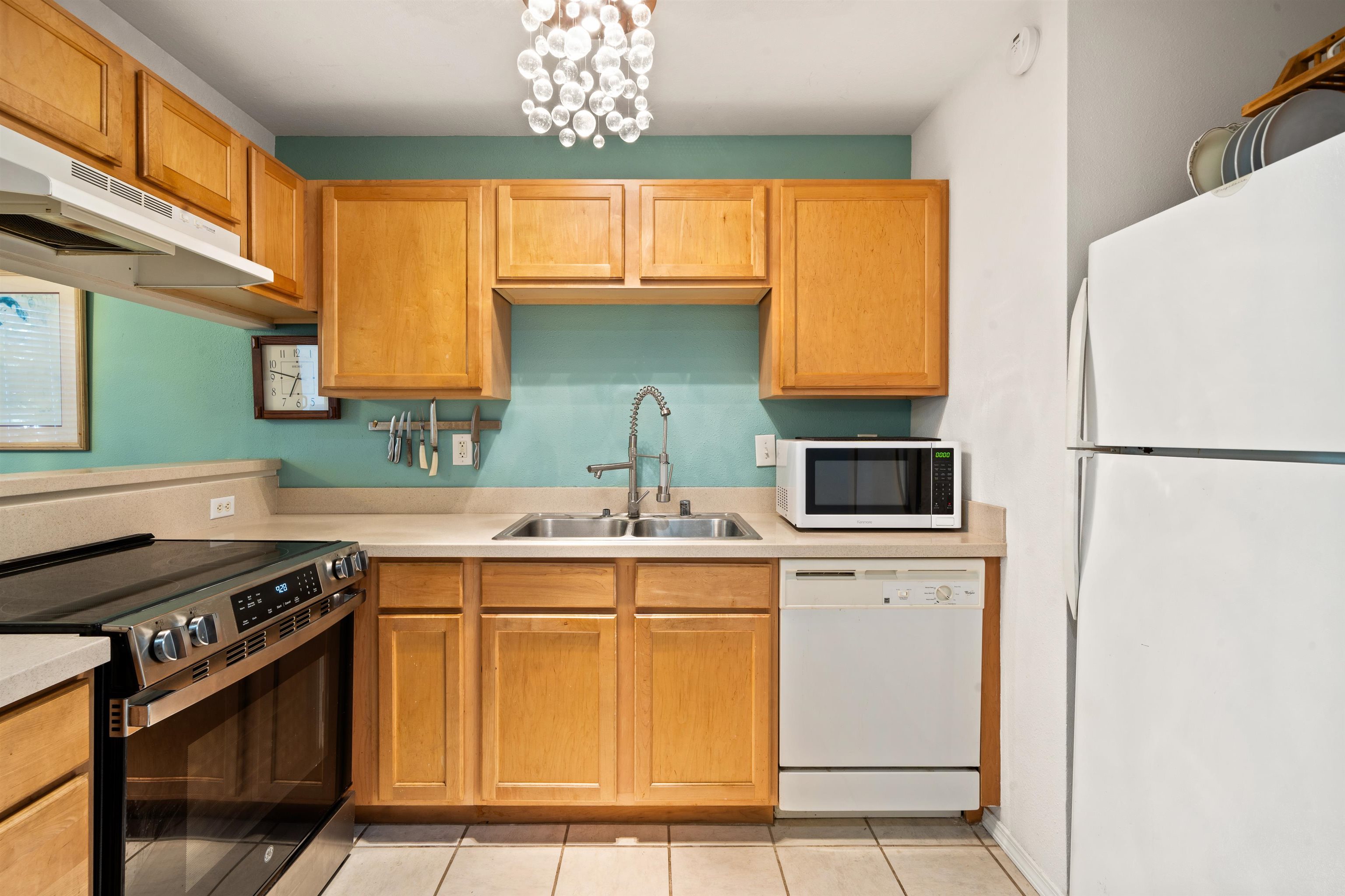 65 Halili Lane, Unit 10F Kihei, HI 96753 - Photo 15 of 48 a kitchen with stainless steel appliances a stove a sink and a refrigerator