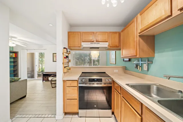 a kitchen with a sink a stove and cabinets