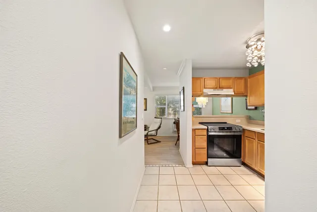 a kitchen with stainless steel appliances granite countertop a sink and a stove