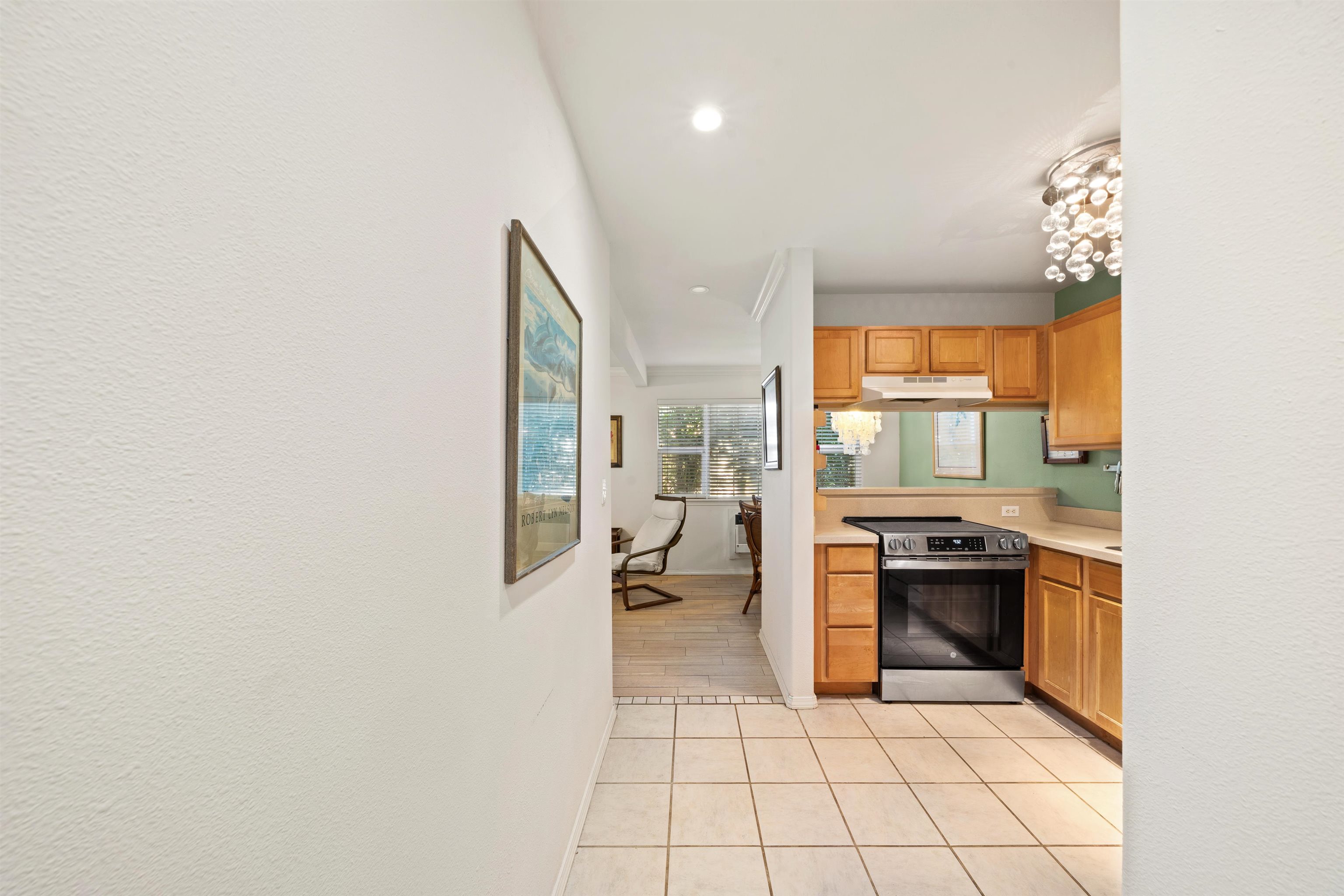 65 Halili Lane, Unit 10F Kihei, HI 96753 - Photo 20 of 48 a kitchen with stainless steel appliances granite countertop a sink and a stove