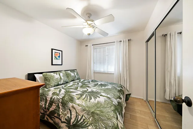 a bed sitting in a bedroom next to a window