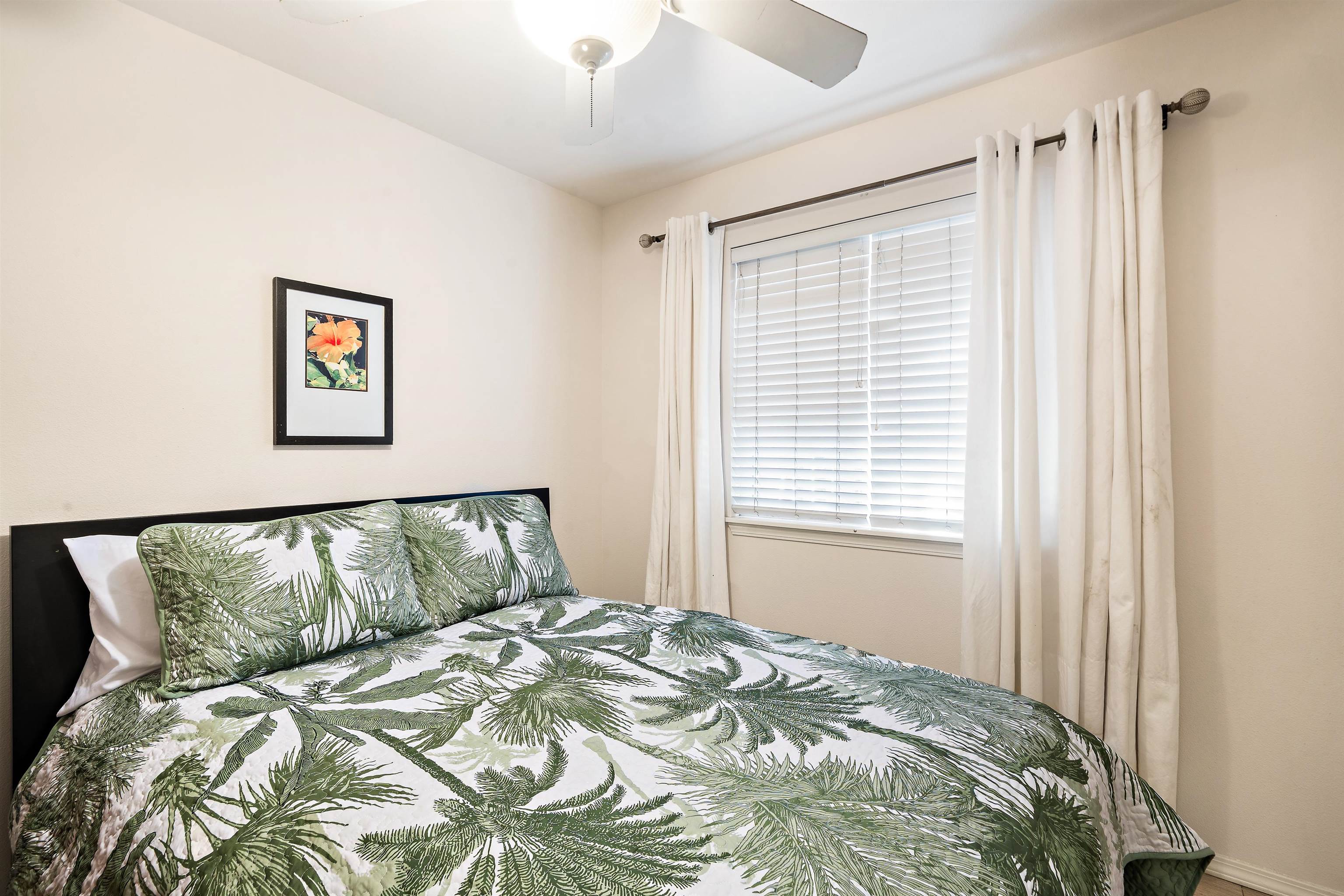 65 Halili Lane, Unit 10F Kihei, HI 96753 - Photo 23 of 48 a bedroom with a bed and a window