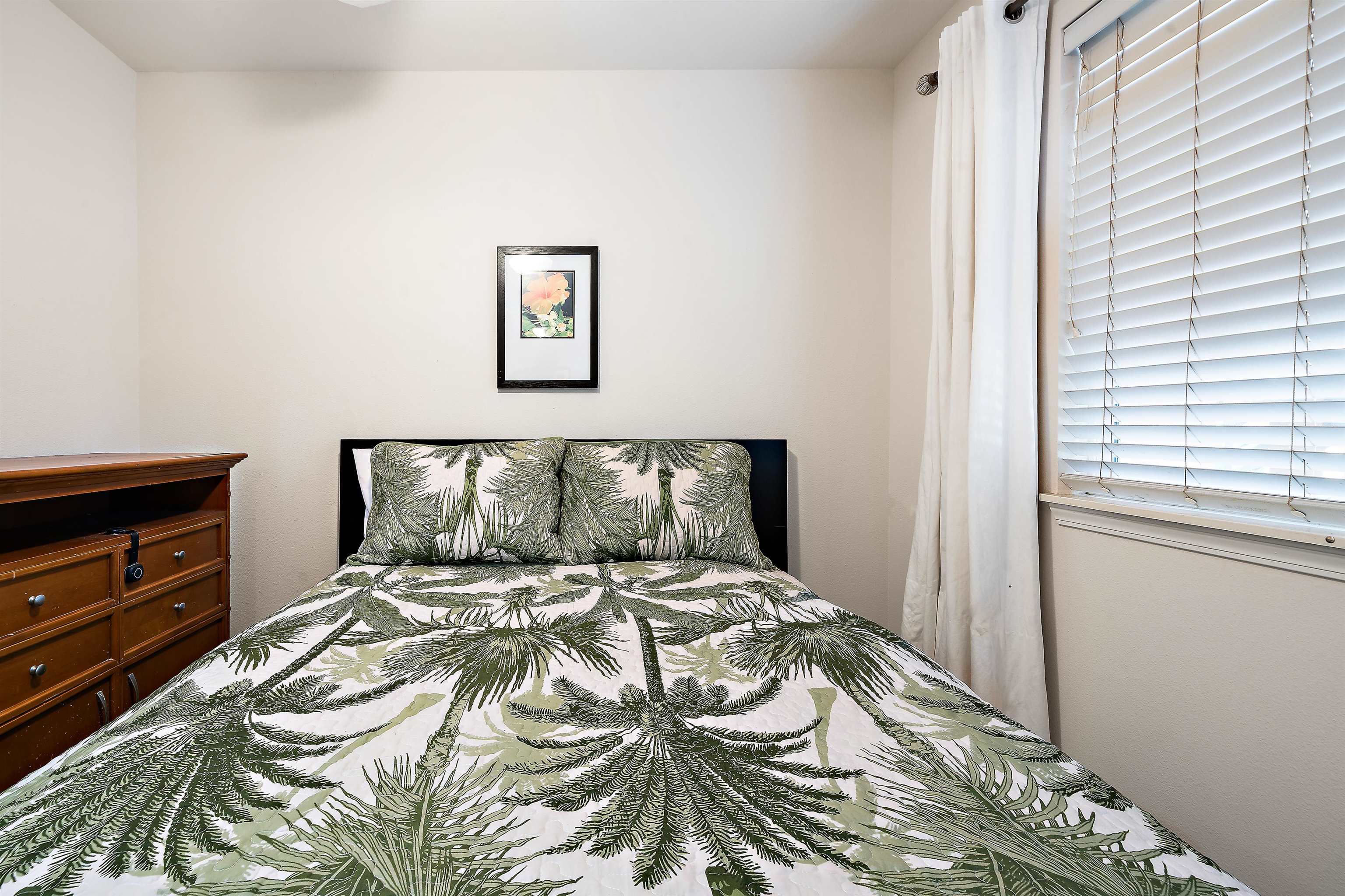 65 Halili Lane, Unit 10F Kihei, HI 96753 - Photo 24 of 48 a bedroom with a bed and a window