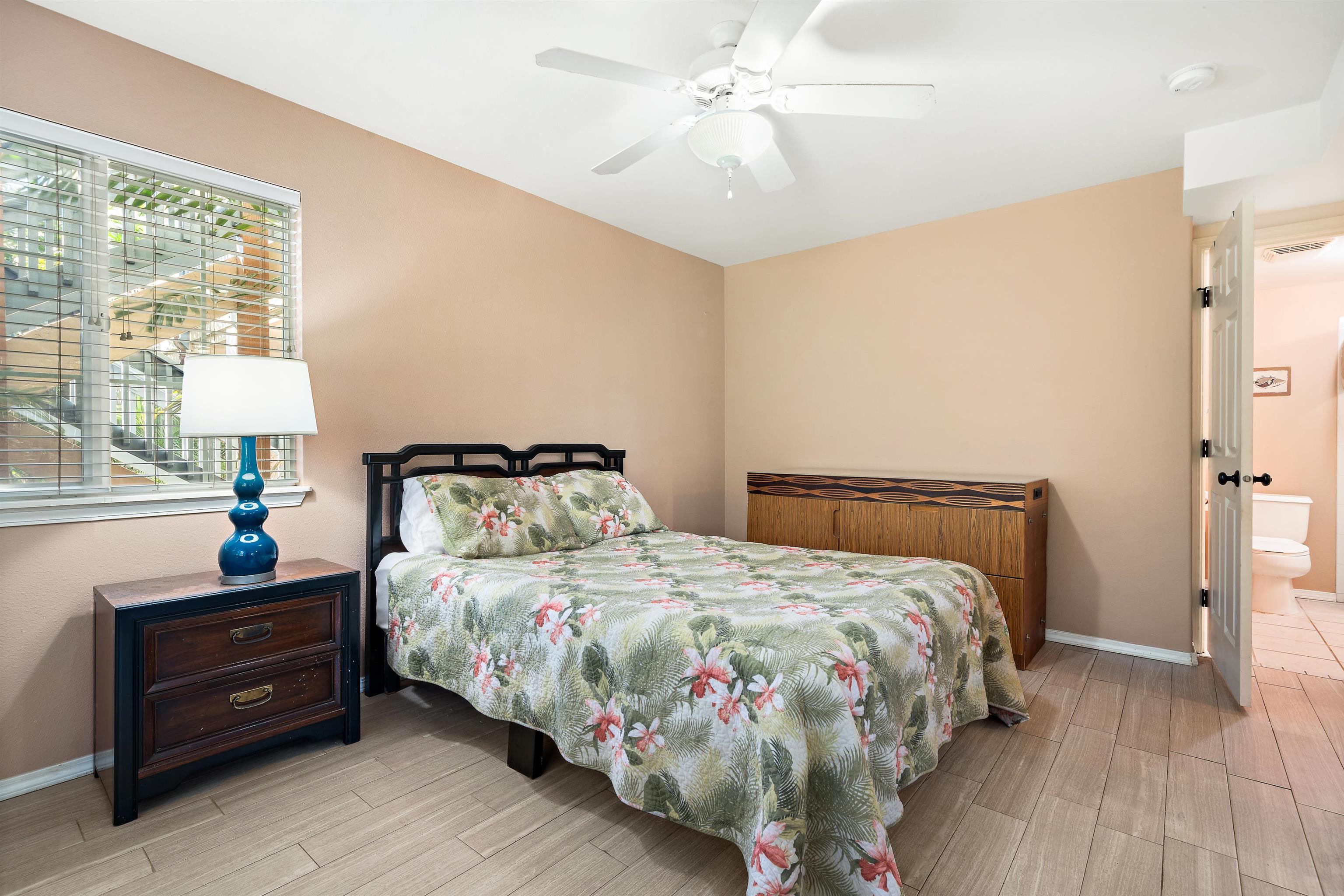 65 Halili Lane, Unit 10F Kihei, HI 96753 - Photo 34 of 48 a bedroom with a bed and window