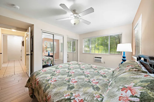 a bedroom with a large bed and a chandelier