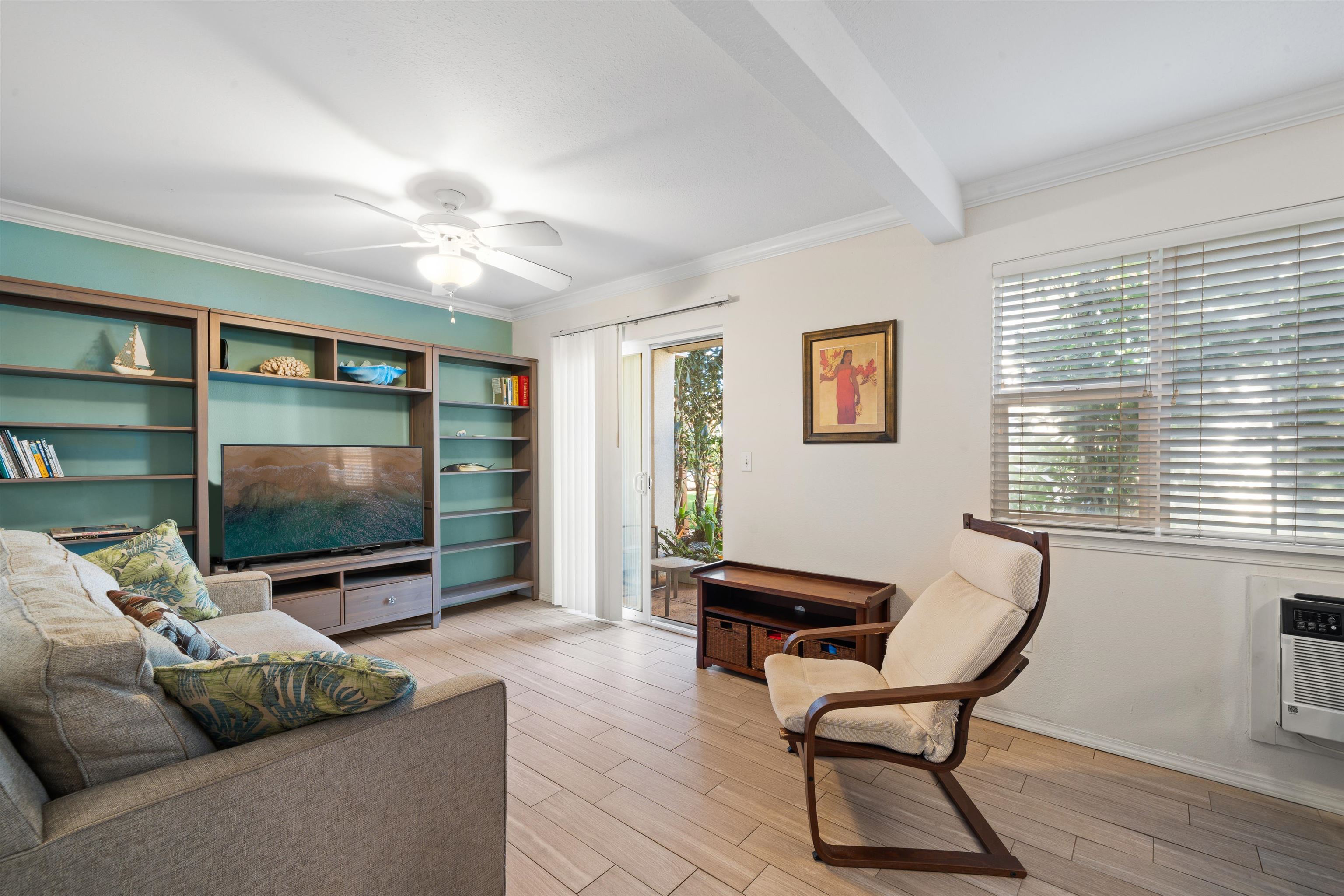 65 Halili Lane, Unit 10F Kihei, HI 96753 - Photo 4 of 48 a living room with furniture and a flat screen tv