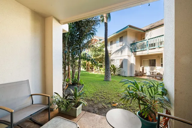 a view of a porch with furniture and a yard