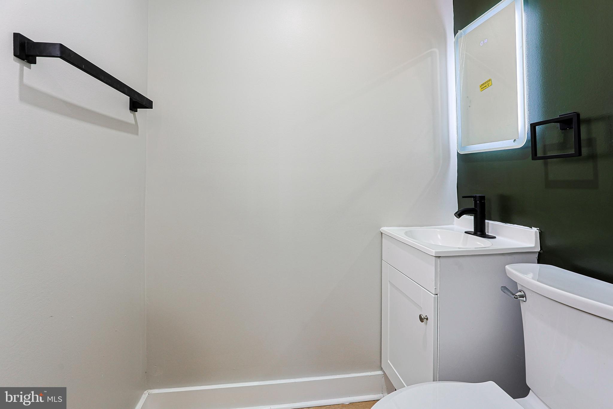 2129 East Tioga Street Philadelphia, PA 19134 - Photo 14 of 32 a bathroom with a sink a toilet and shower