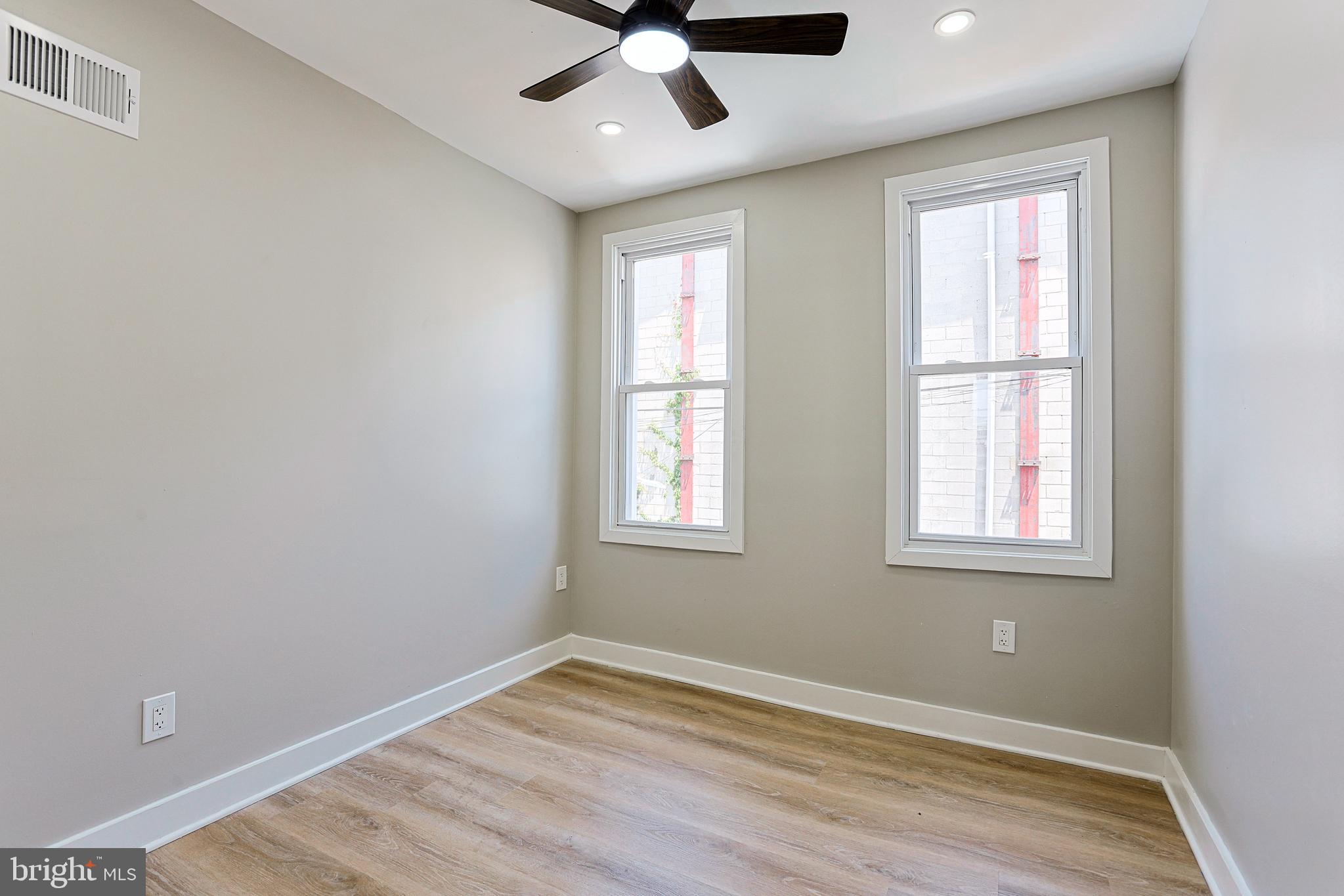 2129 East Tioga Street Philadelphia, PA 19134 - Photo 17 of 32 a view of an empty room with wooden floor and a window