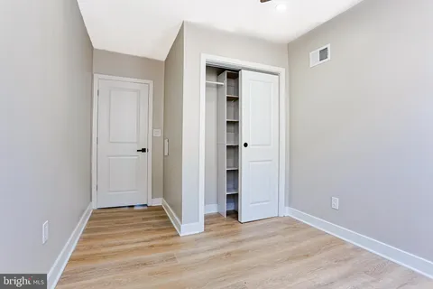 a view of a livingroom with wooden floor and closet