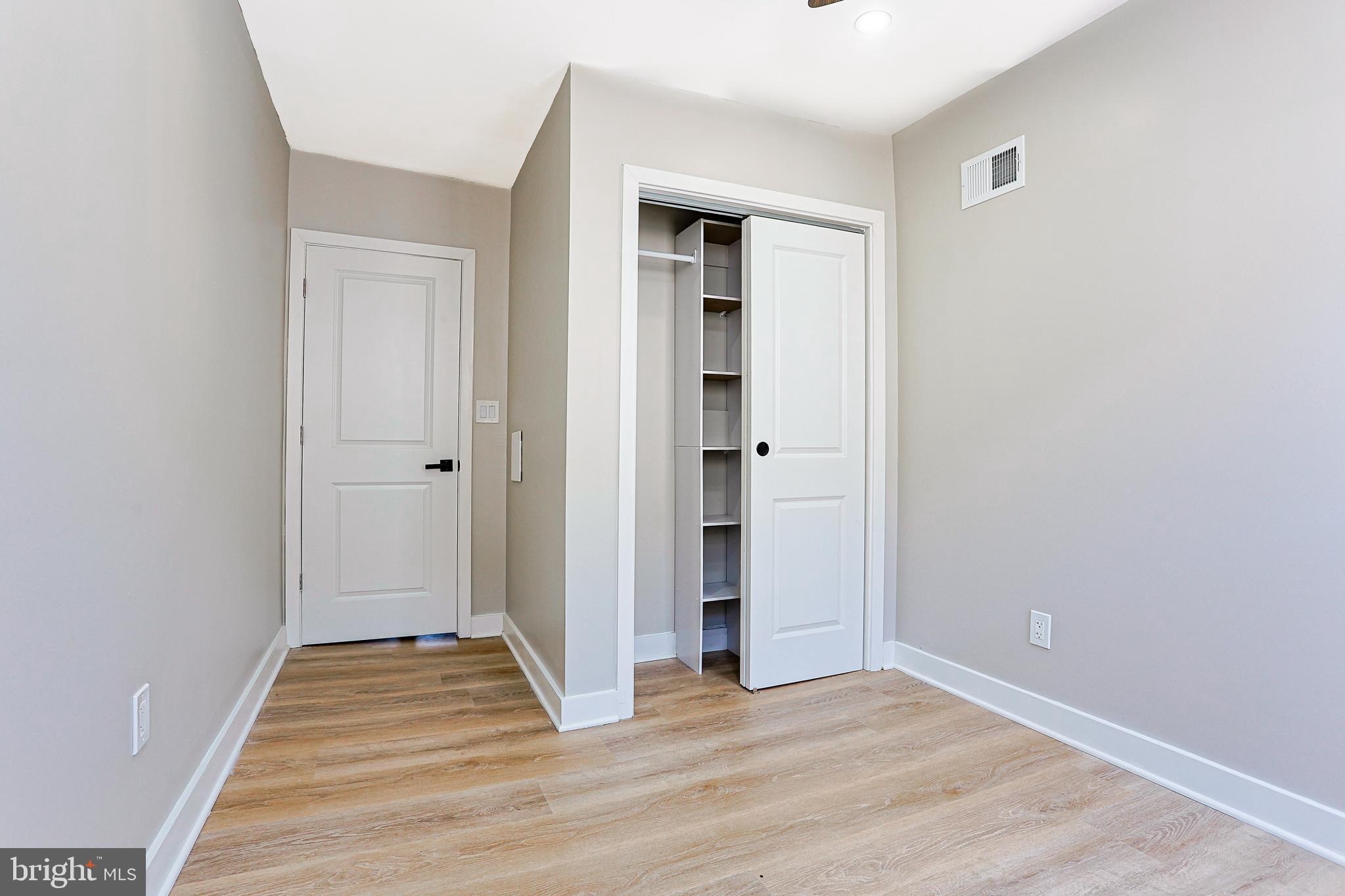 2129 East Tioga Street Philadelphia, PA 19134 - Photo 18 of 32 a view of a livingroom with wooden floor and closet