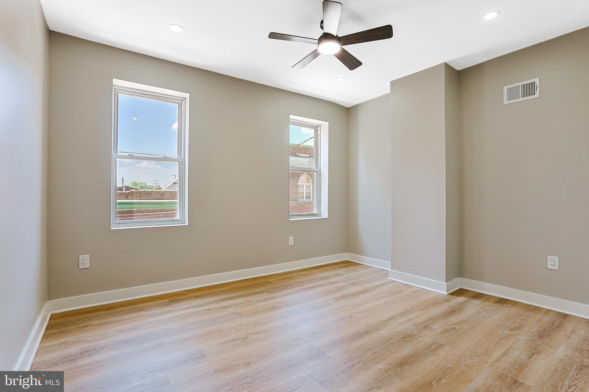 2129 East Tioga Street Philadelphia, PA 19134 - Photo 21 of 32 a view of an empty room with wooden floor and a window