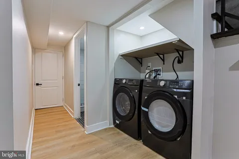 a view of a storage & utility room with washing machine