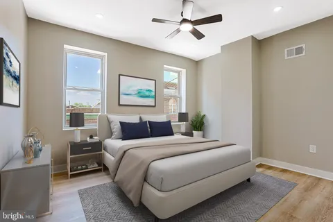 a bedroom with a bed and wooden floor