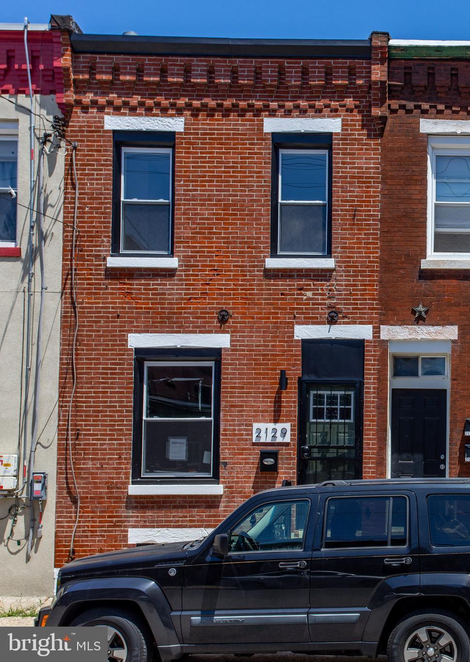 2129 East Tioga Street Philadelphia, PA 19134 - Photo 5 of 32 a outdoor view of a building with car parked
