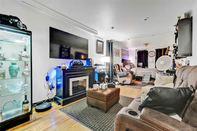 a living room with furniture a flat screen tv and a fireplace