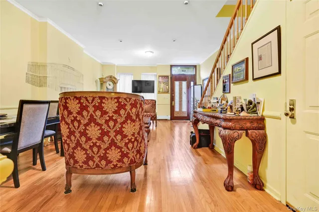 a living room with furniture a dining table and wooden floor